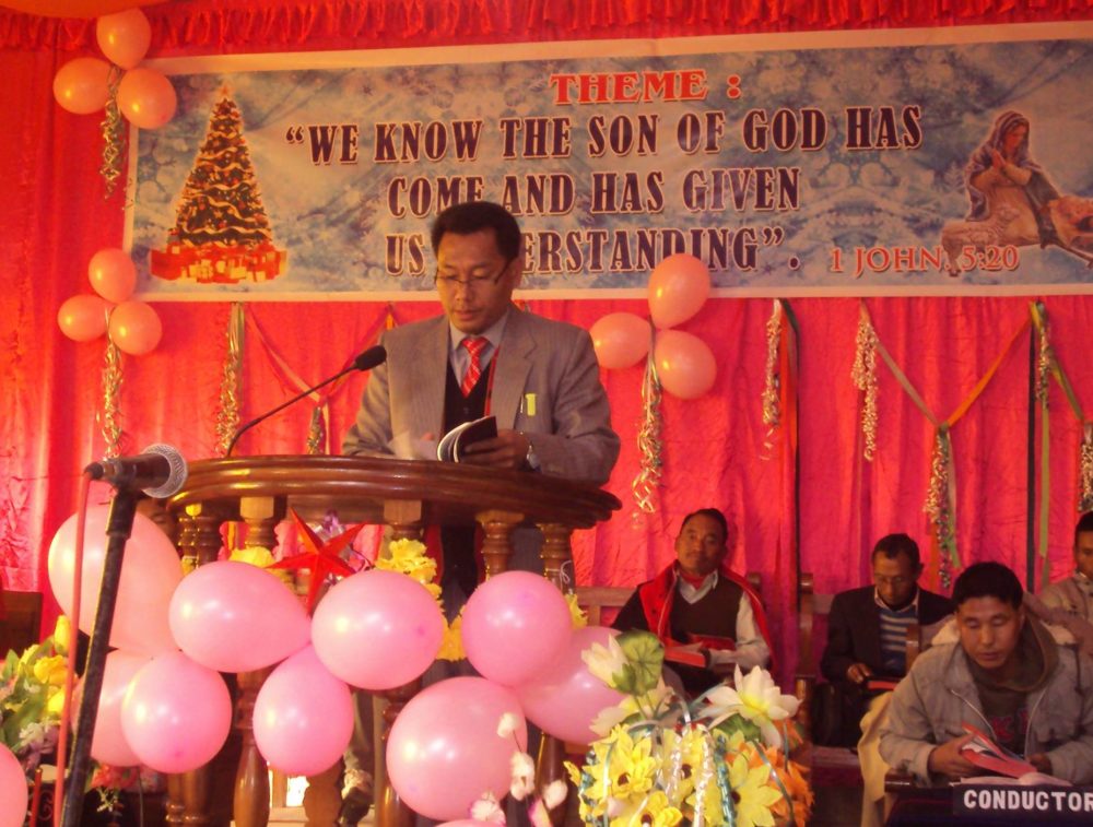 Pastor Ashang preaches.